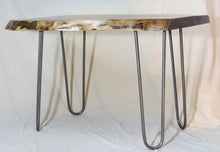 Load image into Gallery viewer,  live edge side or accent table comprised of black walnut slab with hand-forged hairpin legs for a cool mid-century modern look. Slab is hand finished and accented with a single cherry bowtie inlay