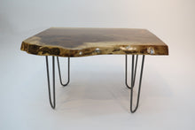 Load image into Gallery viewer,  live edge side or accent table comprised of black walnut slab with hand-forged hairpin legs for a cool mid-century modern look. Slab is hand finished and accented with a single cherry bowtie inlay