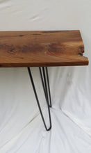 Load image into Gallery viewer, live edge console or hall table, comprising of beautifulhand finished black walnut board atop tall hand-forged hairpin legs for a cool mid-century modern look