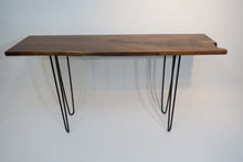 Load image into Gallery viewer, live edge console or hall table, comprising of beautifulhand finished black walnut board atop tall hand-forged hairpin legs for a cool mid-century modern look