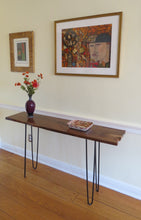Load image into Gallery viewer, live edge console or hall table, comprising of beautifulhand finished black walnut board atop tall hand-forged hairpin legs for a cool mid-century modern look