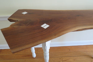 live edge black walnut console or hall table, comprising intricate crotch slab and distressed, upcycled white legs.  Unique, hancrafted, three-legged, cantilevered design