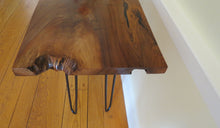 Load image into Gallery viewer, live edge console or hall table, comprising of beautifulhand finished black walnut board atop tall hand-forged hairpin legs for a cool mid-century modern look