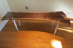 unique hancrafted live edge table in black walnut. Coffee table comprises beautiful crotch slab with white distressed legs that are through-tenoned for a modern look